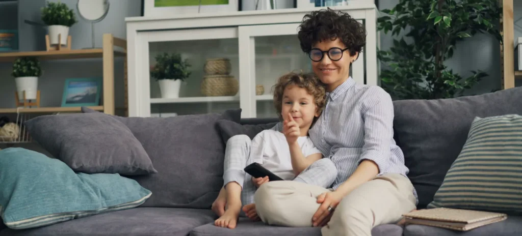 Mother and child sitting comfortably on a living room couch